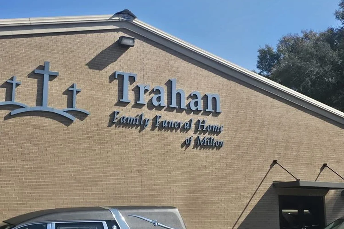 Funeral home planning guide with a calm memorial arrangement and paperwork on a table